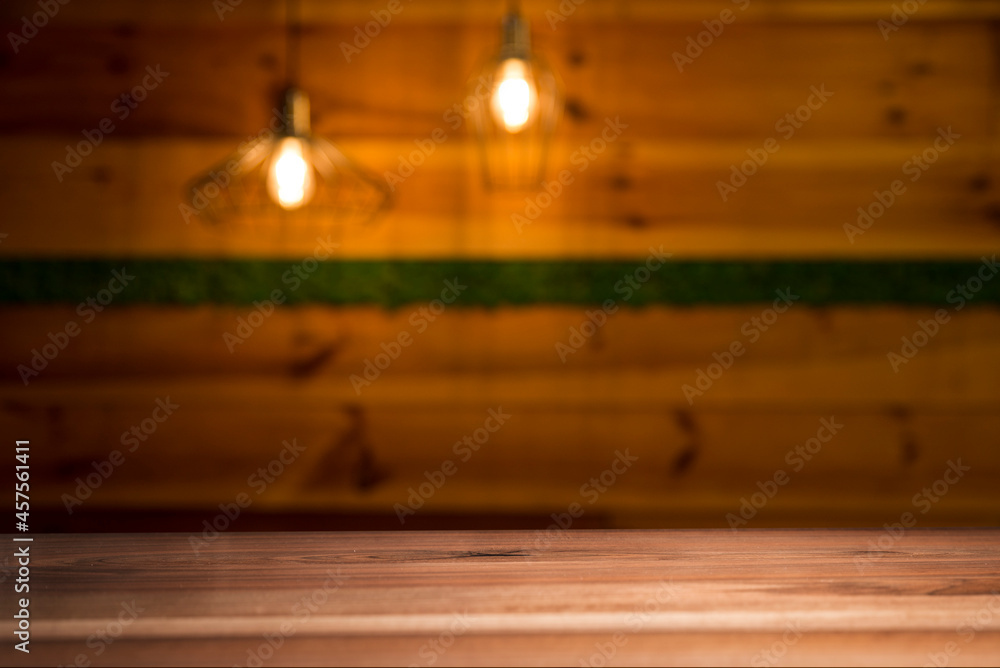 image of wooden table in front of abstract blurred background of restaurant lights image of wooden table in front of abstract blurred background of restaurant lights