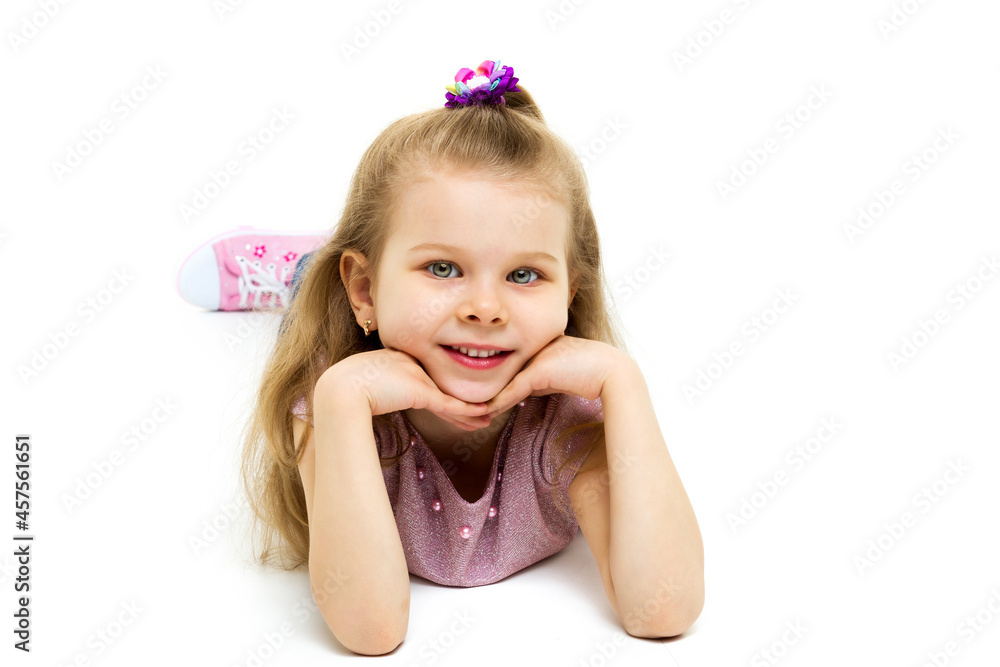Charming girl lying on floor hands under her chin Charming girl lying on floor hands under her chin