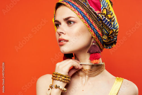 cheerful woman multicolored shawl ethnicity african style decorations red background
