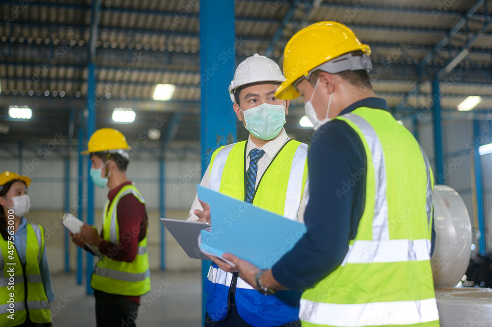 Engineer people are wearing protective mask working in warehouse Engineer people are wearing protective mask working in warehouse