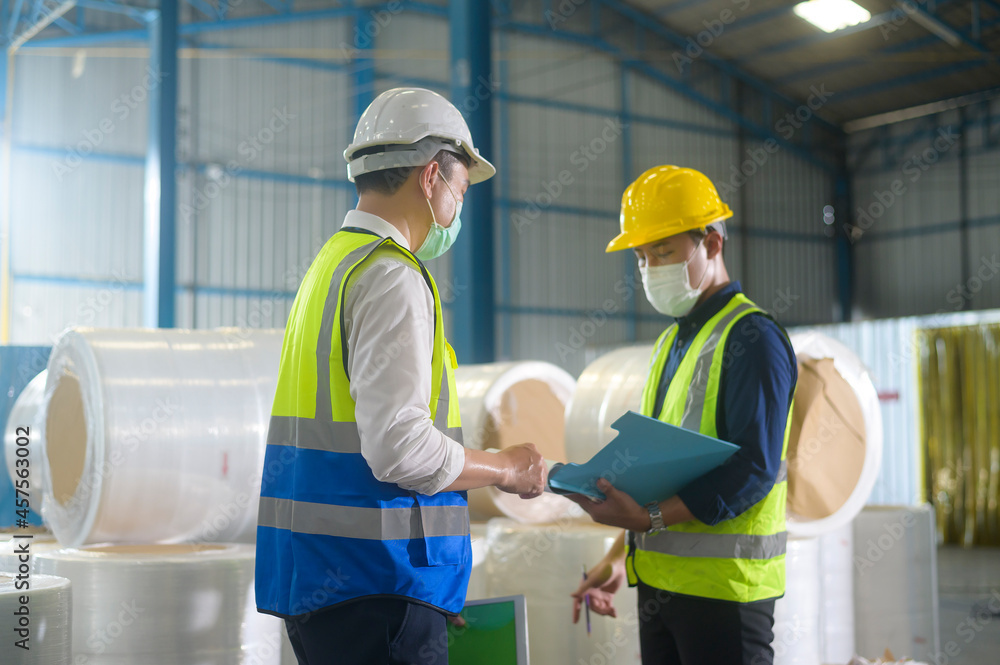 Engineer people are wearing protective mask working in warehouse Engineer people are wearing protective mask working in warehouse