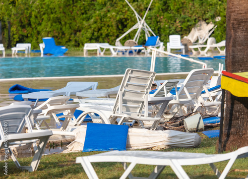 Straw loungers and sun loungers at the water park after tornado.