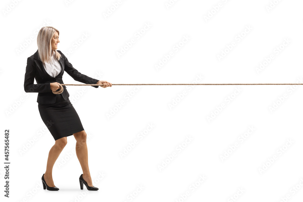 Full length profile shot of a young attractive businesswoman pulling a rope Full length profile shot of a young attractive businesswoman pulling a rope