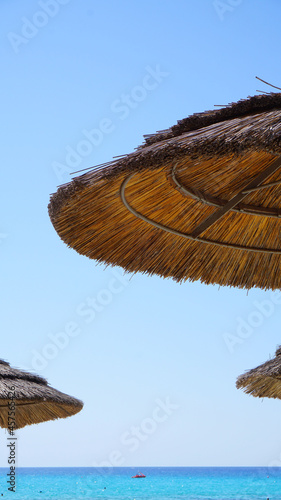 beach straw umbrellas from the sun on the background of the blue sky sea resort vacation summer vacation sun