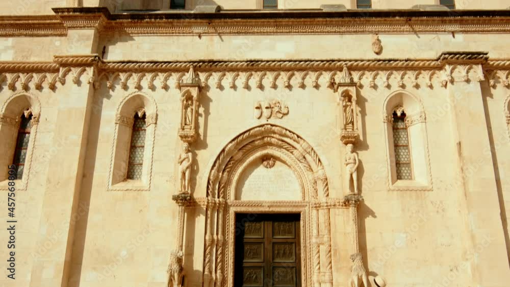 Young tourist walking by the old church in Sibenik Young tourist walking by the old church in Sibenik