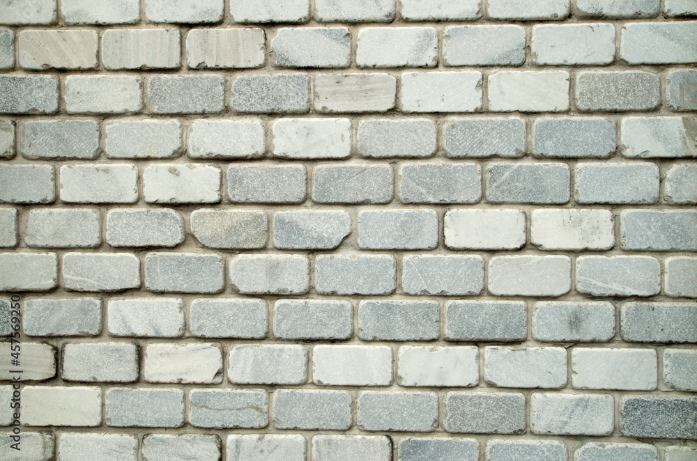 New light decorative marble bricks on wall close New light decorative marble bricks on wall close