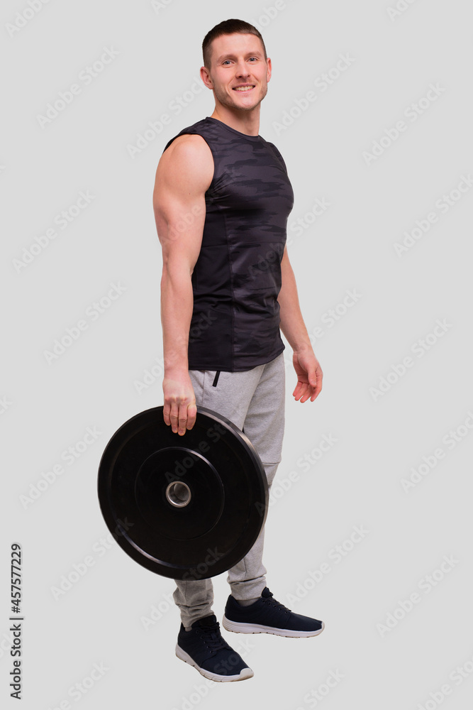 Sportsman with Barbell Pancakes in Hands. Man Doing Workout with Barbells. Man Workout. Sportsman Standing Sportsman with Barbell Pancakes in Hands. Man Doing Workout with Barbells. Man Workout. Sportsman Standing