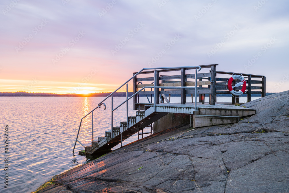 Stockholm, Sweden - Sep 14th 2021: bathing jetty with stairs to Baltic sea in Stockholm Sweden in stunning sunrise on a autumn morning