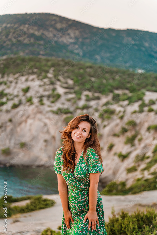 A beautiful young woman in a dress on Cape Kapchik in the Crimea. Romantic seascape