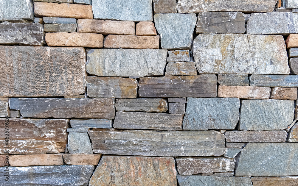 Fototapeta premium rough stone wall closeup, seamless natural background