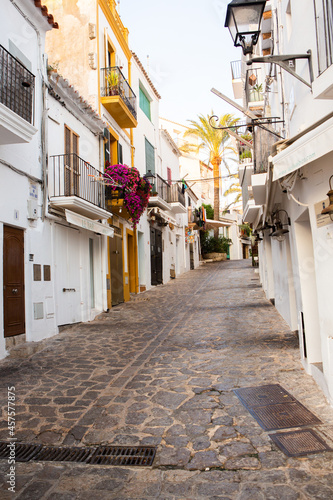 Fototapeta Naklejka Na Ścianę i Meble -  The architecture of the island of Ibiza. A charming empty white street in the old town of Eivissa