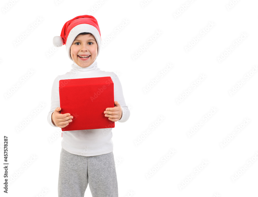 Smiling little boy in santa claus hat holding red box in hands on white isolated background, New Year, Christmas Smiling little boy in santa claus hat holding red box in hands on white isolated background, New Year, Christmas