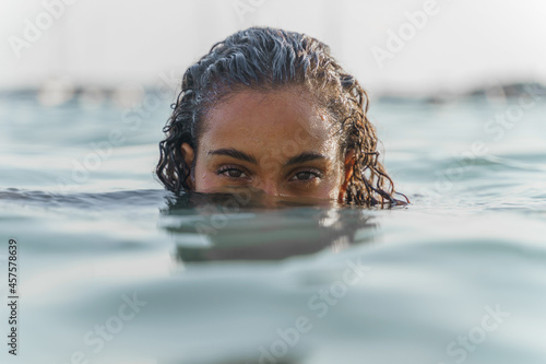 Woman with half head underwater in the sea © Alberto Case