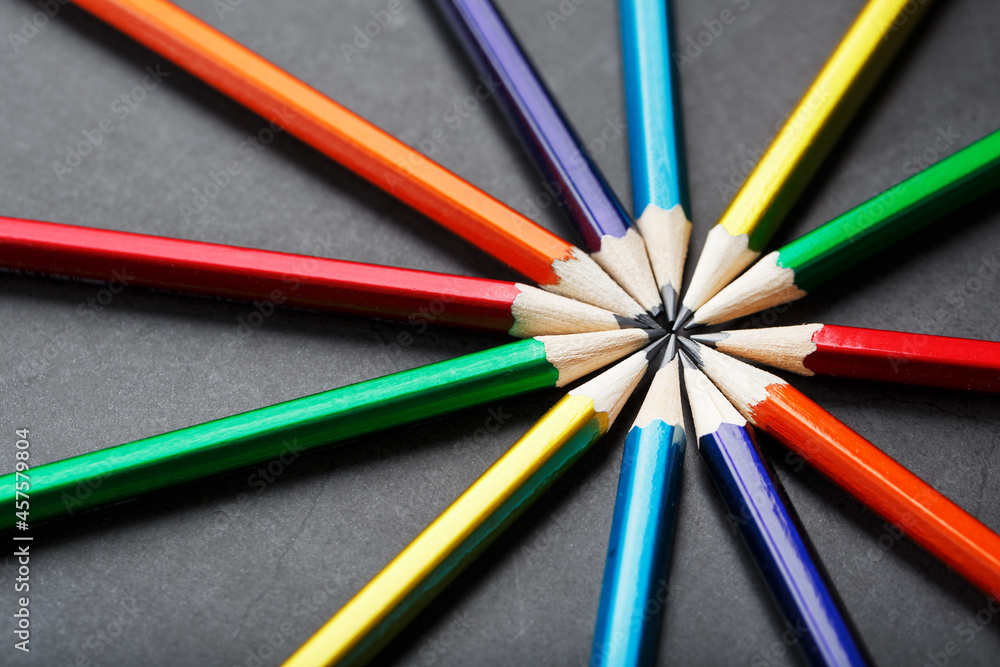 Multicolored pencils in the shape of a star on a black background. Multicolored pencils in the shape of a star on a black background.