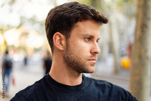 Young man with stylish haircut in city