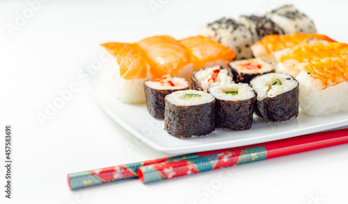 Set of smoked salmon nigiri, Ebi king prawn nigiri, sweet chilli pawn and red pepper California roll, cucumber with wasabi hosomaki roll and red pepper hosomaki roll