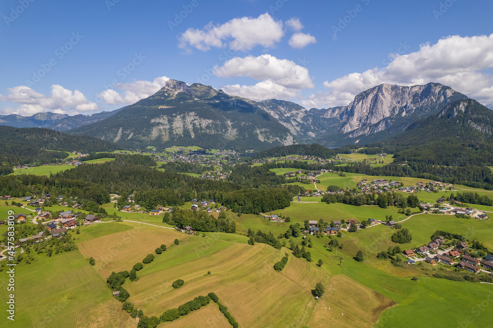 Aerial view of the village, fields and forest in mountains Alps Austria