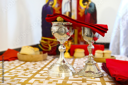 Orthodox faith. Gold and silver bowls for communion are covered with a red cloth on the throne of the Orthodox Church. The concept of Orthodoxy. photo