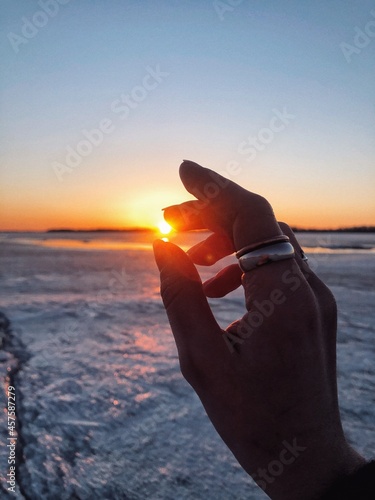 hand holding a sun © Elena Yachminskaya