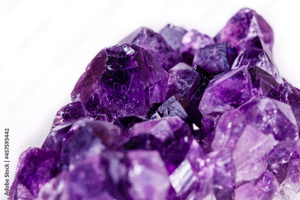Fototapeta premium Macro mineral stone purple amethyst in crystals on a white background