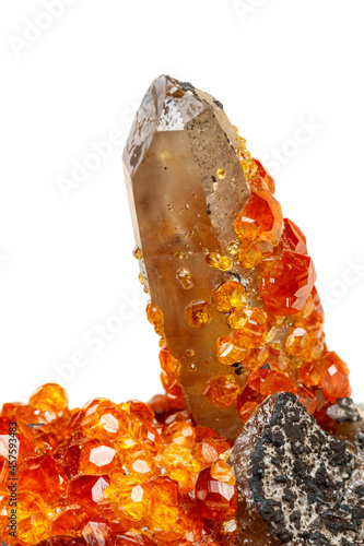 macro mineral stone Spessartine, orange, red garnet with quartz on white background photo