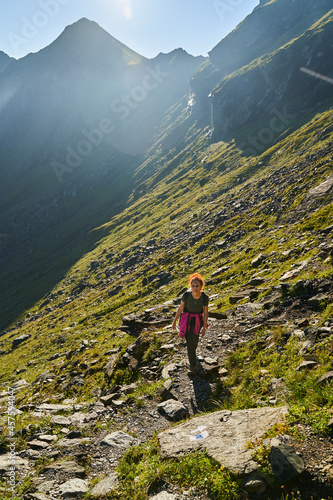 Woman hiker with backpack on a trail in the mountains © Xalanx