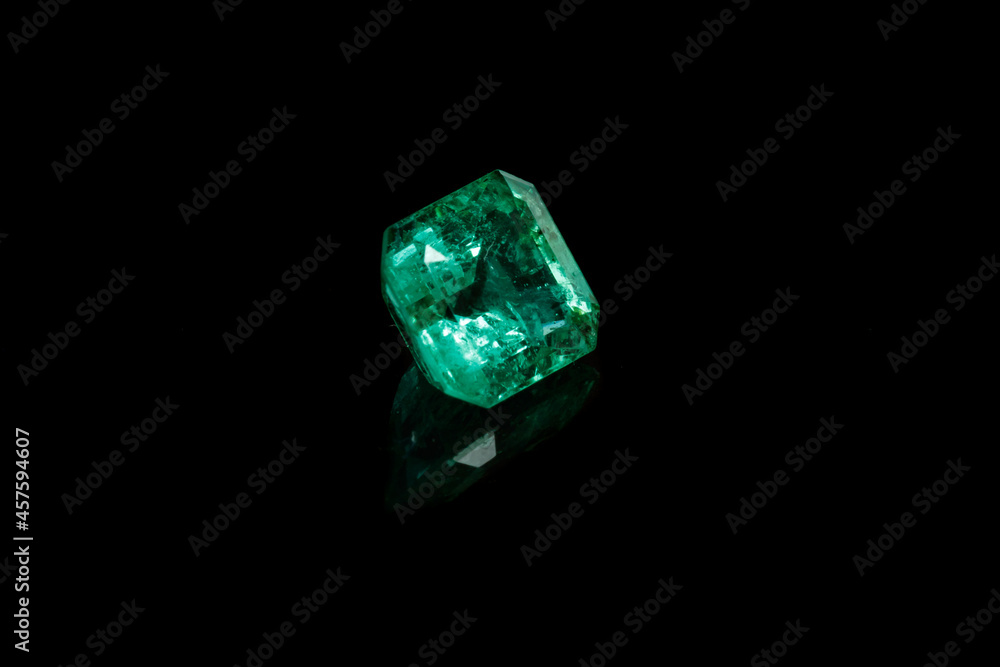 Macro mineral Emerald gemstone faceted on black background Macro mineral Emerald gemstone faceted on black background