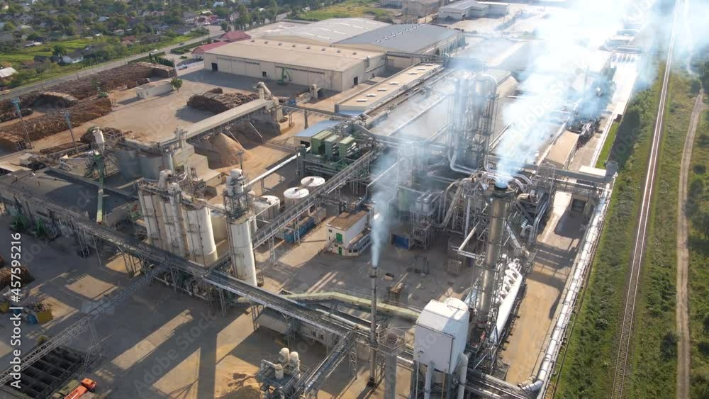 Aerial view of wood processing factory with stacks of lumber at plant manufacturing yard. Aerial view of wood processing factory with stacks of lumber at plant manufacturing yard.