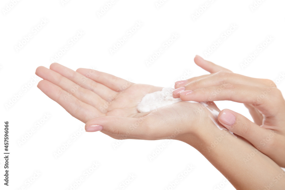 beautiful woman hand on a white background presses on a bottle of spa cleansing foam. isolate beautiful woman hand on a white background presses on a bottle of spa cleansing foam. isolate