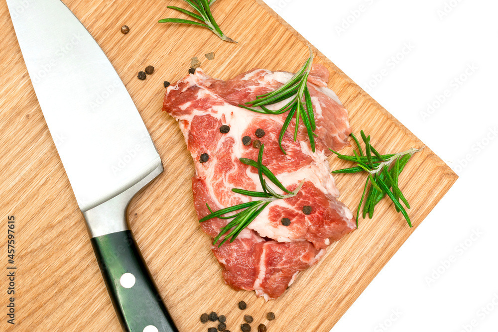 Raw fresh beef meat steaks with rosemary, pepper and knife on cutting board isolated on white background close up food cooking at home Raw fresh beef meat steaks with rosemary, pepper and knife on cutting board isolated on white background close up food cooking at home