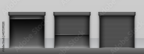 Set of black roller shutter gates on light grey wall of building. Open and closed roller shutter doors. Metal industrial shutter doors.