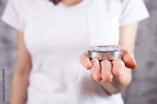 young girl holding a compass indoors