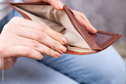young girl showing empty wallet photo