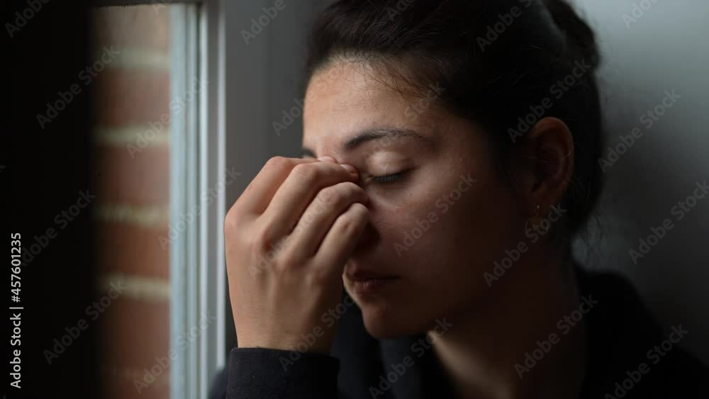 Tired woman anguish emotion sitting by window. Person emotional suffering Tired woman anguish emotion sitting by window. Person emotional suffering
