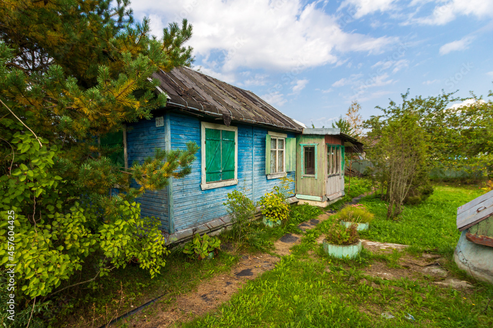 Typical architecture dacha. seasonal, year-round second home in exurbs. Village summer houses in forest. Poor Soviet housing. Electricity supply, electric wire. Typical architecture dacha. seasonal, year-round second home in exurbs. Village summer houses in forest. Poor Soviet housing. Electricity supply, electric wire.