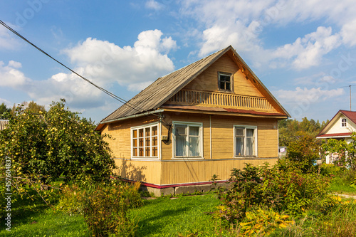 Typical architecture dacha. seasonal, year-round second home in exurbs. Village summer houses in forest. Poor Soviet housing. Electricity supply, electric wire.