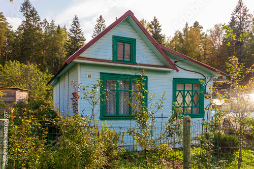 Typical architecture dacha. seasonal, year-round second home in exurbs. Village summer houses in forest. Poor Soviet housing. Electricity supply, electric wire. photo