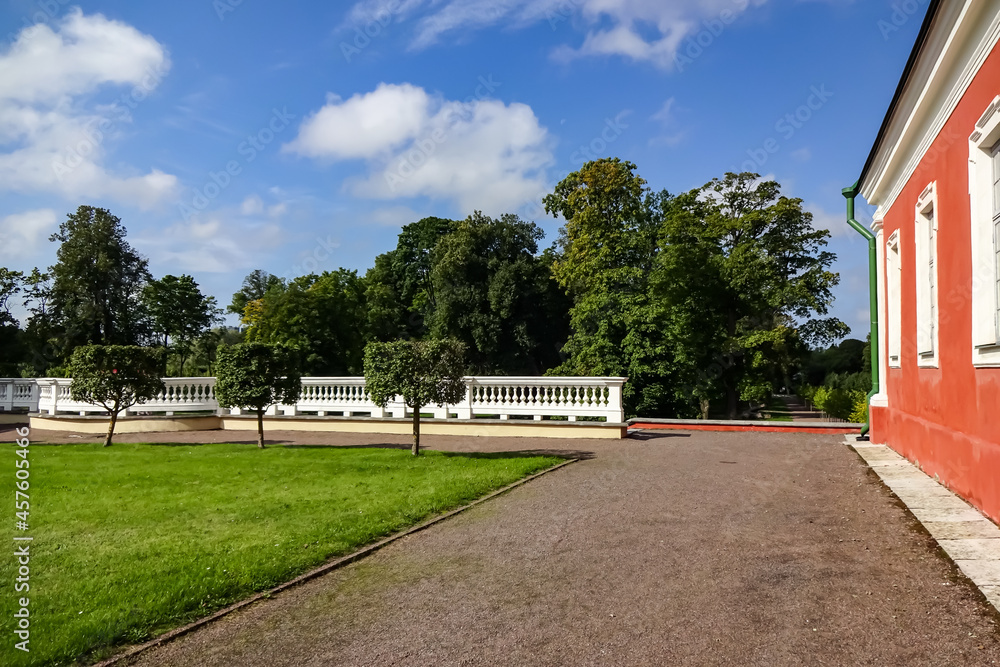 Landscape in Kadriorg park. Green trees on the back. Red building facade on the right. Green grass. Tallinn. Estonia, Europe. August 2021