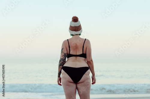 Anonymous winter bather standing at the beach