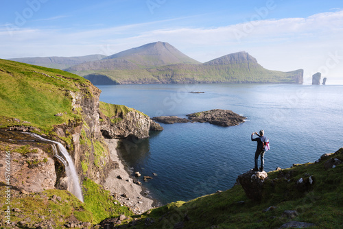 Skardsafossur waterfall and Drangarnir sea stacks view on Faroe Islands photo