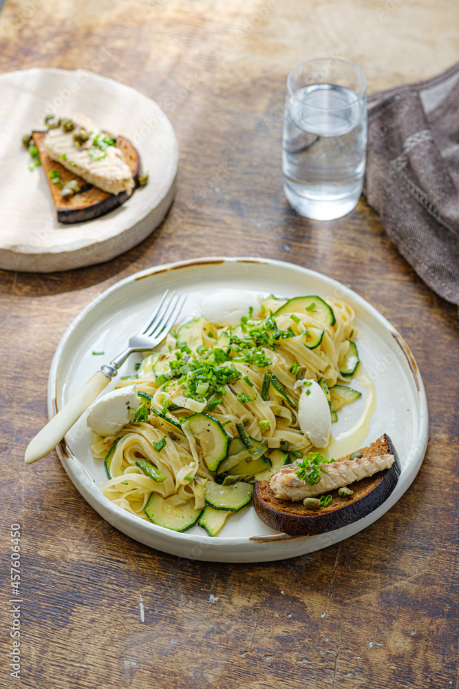 Spaghetti with zucchini and basil pesto on a white plate, rustic style Spaghetti with zucchini and basil pesto on a white plate, rustic style
