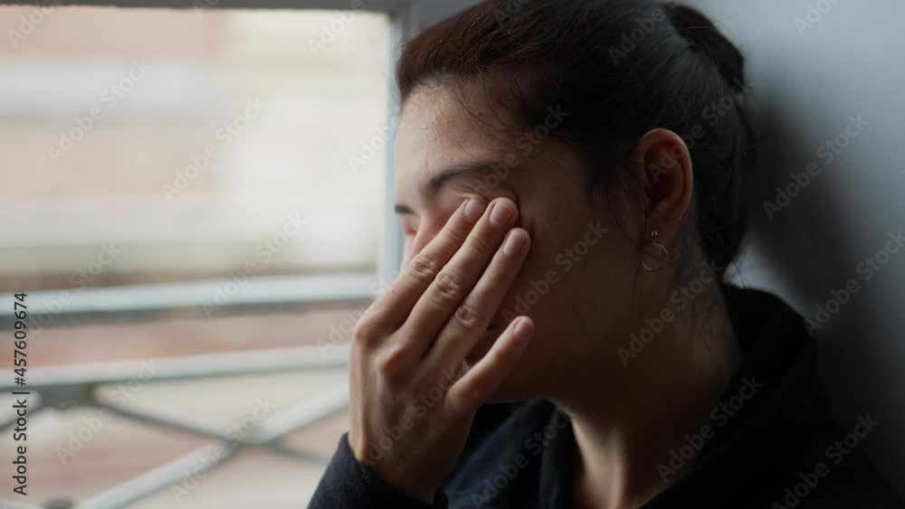 Woman rubbing eye with hand. Tired person rubs eyes and face Woman rubbing eye with hand. Tired person rubs eyes and face