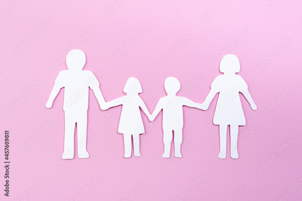 Paper family cut out on bright pink background. Family home, foster care, family mental health, divorce and family crisis concept Paper family cut out on bright pink background. Family home, foster care, family mental health, divorce and family crisis concept