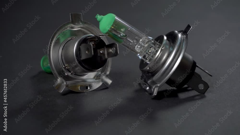 Halogen bulbs for car, panning vertically on black background, H4 Halogen bulbs for car, panning vertically on black background, H4