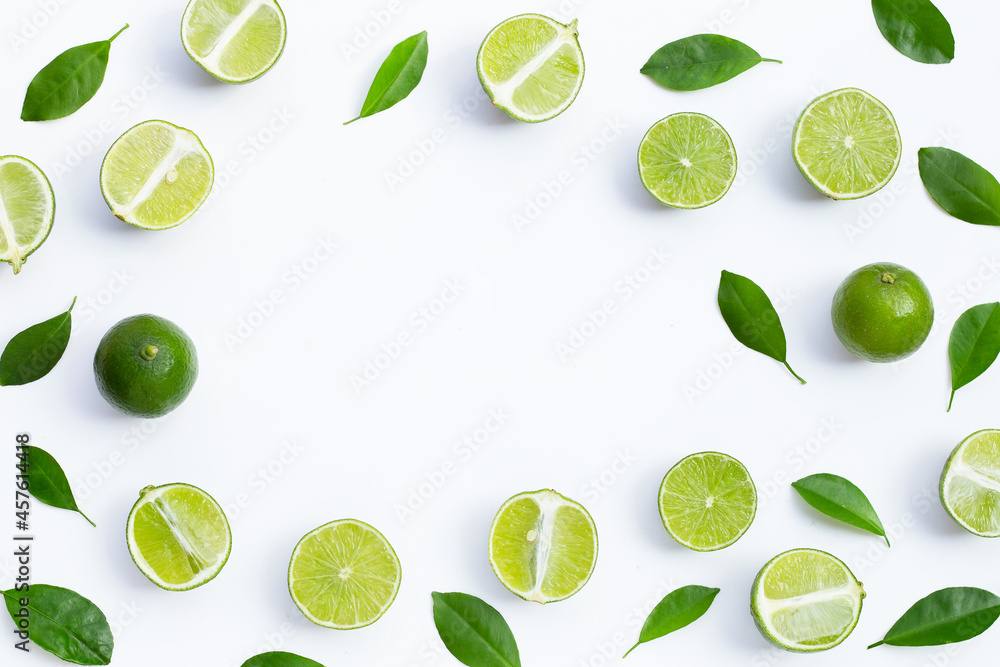 Frame made of fresh limes with green leaves on white background. Top view Frame made of fresh limes with green leaves on white background. Top view