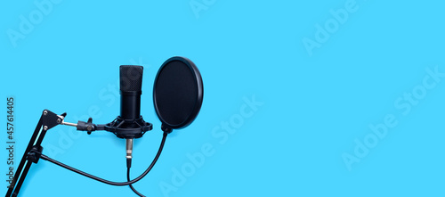 Studio microphone on blue background.