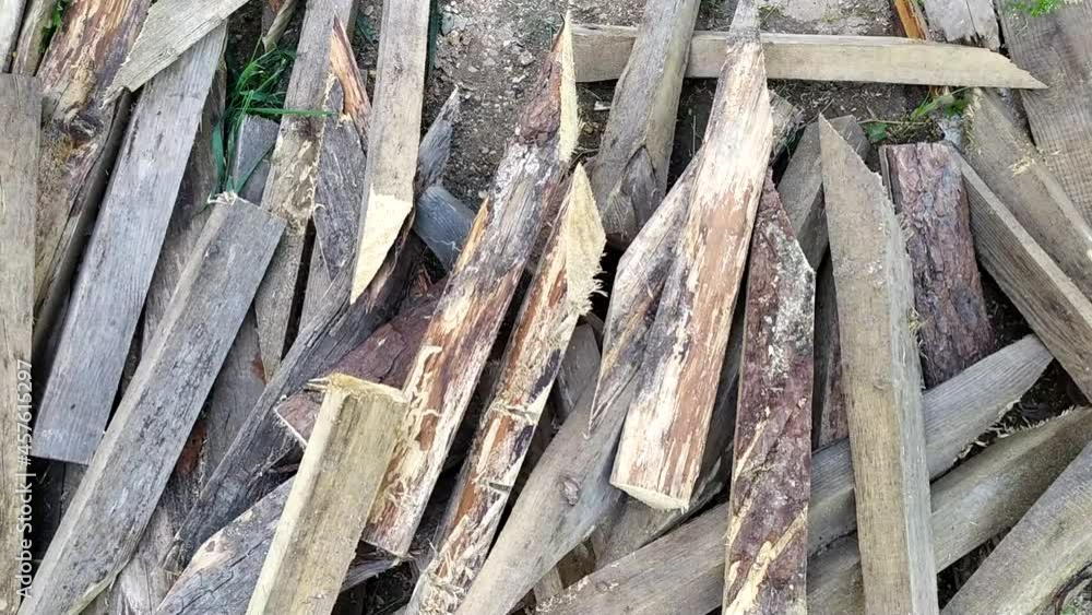 Firewood. Waste wood for kindling the stove. A pile of wooden boards for heating the room in the cold season. Firewood. Waste wood for kindling the stove. A pile of wooden boards for heating the room in the cold season.