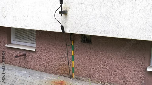 Residential Area Apartments Block Lightning Rod Grounded Using Green and Yellow Metal Strip photo