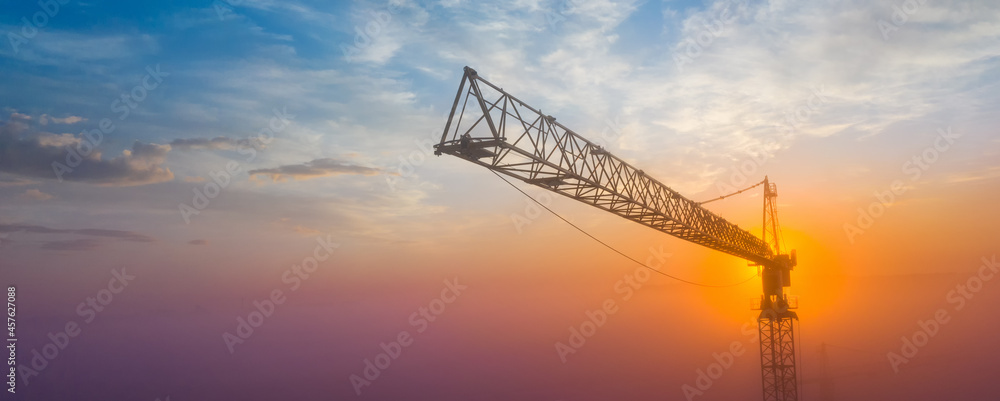 Construction tower crane on the background of the morning sky. Construction tower crane on the background of the morning sky.