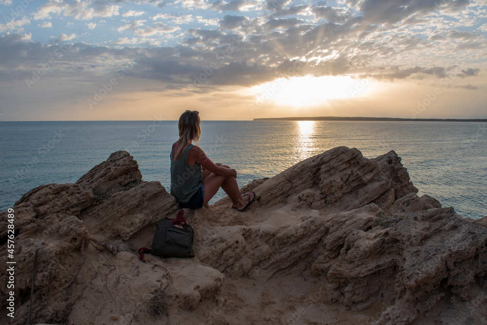 Young blonde woman in Calo d es Mort on the island of Formentera in Spain in summer 2021 Young blonde woman in Calo d es Mort on the island of Formentera in Spain in summer 2021